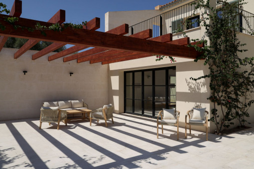 Zona lounge cubierta bajo una elegante pérgola