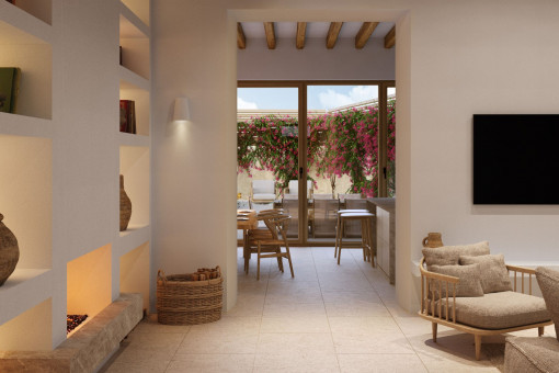 Acogedor salón con chimenea y vistas al patio mediterráneo