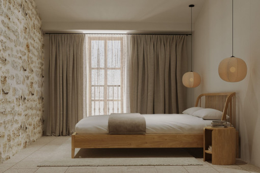 Dormitorio de invitados con pared de piedra y luz cálida