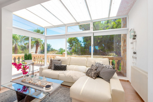 Salón luminoso con chimenea y acceso a la soleada terraza con vistas abiertas