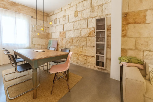 Dining area with rustic stone wall