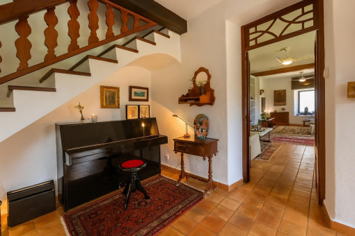 Entrada acogedora con piano y escaleras